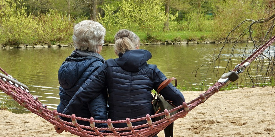 Daughter & Mother with Dementia Sitting by the Pond