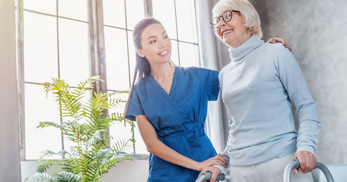 Asian Nurse Helping Senior Woman Walk