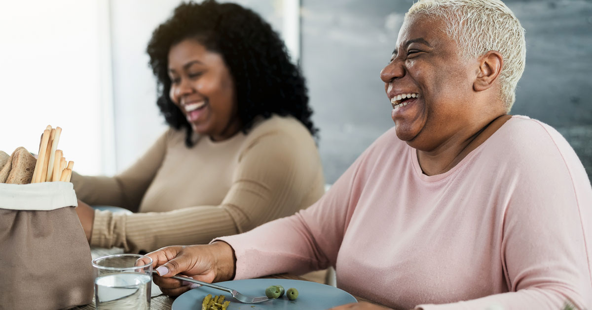 Black Mother and Daughter Eating a Meal Together