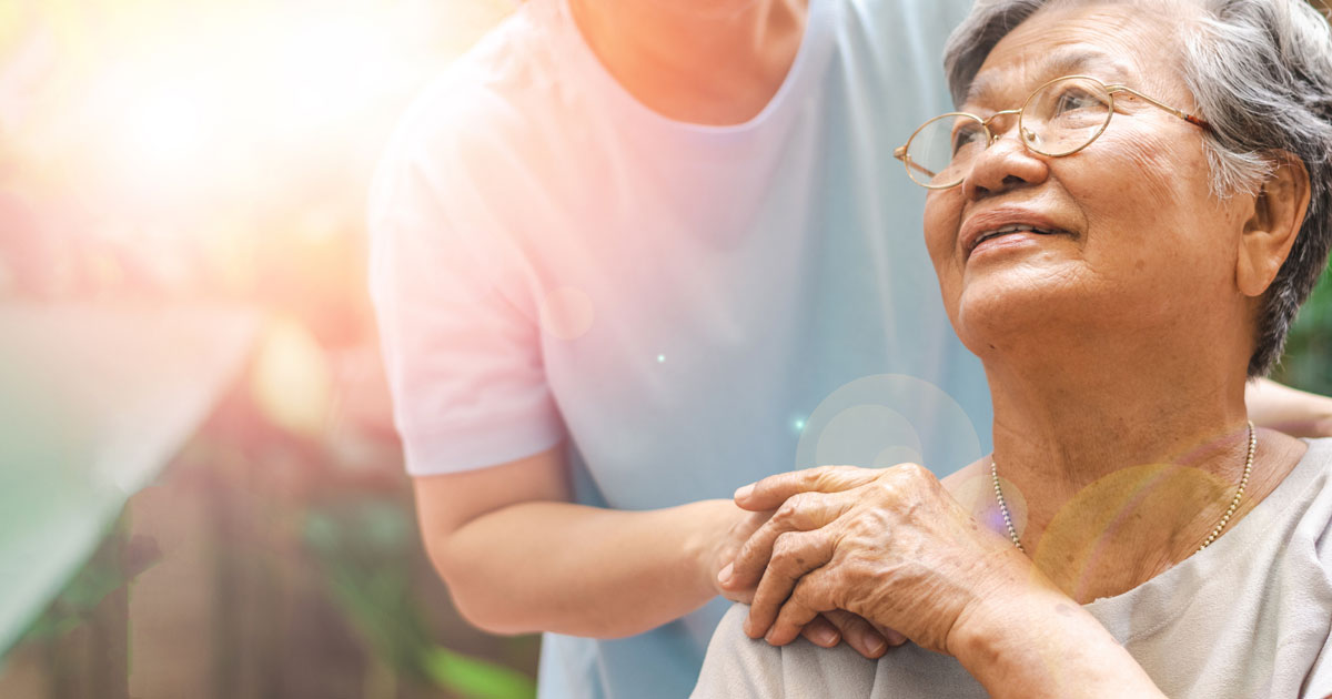 Caregiver Holding Elderly Woman's Hand