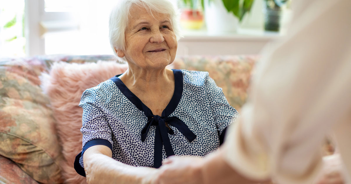 Caretaker Helping Elderly Woman Stand Up