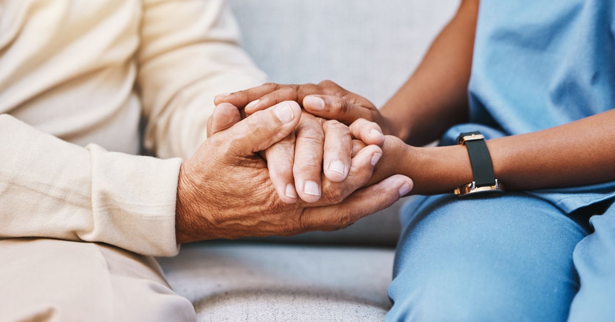 Caregiver Holding Patient's Hands