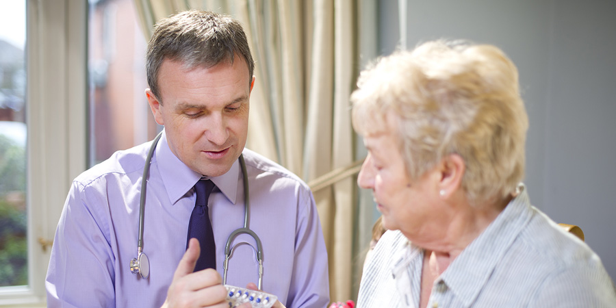 Doctor Giving Elderly Female Patient Medicine Instructions