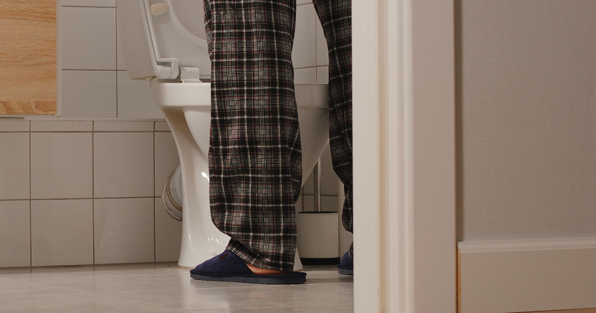 Elderly Man Peeing in Toilet