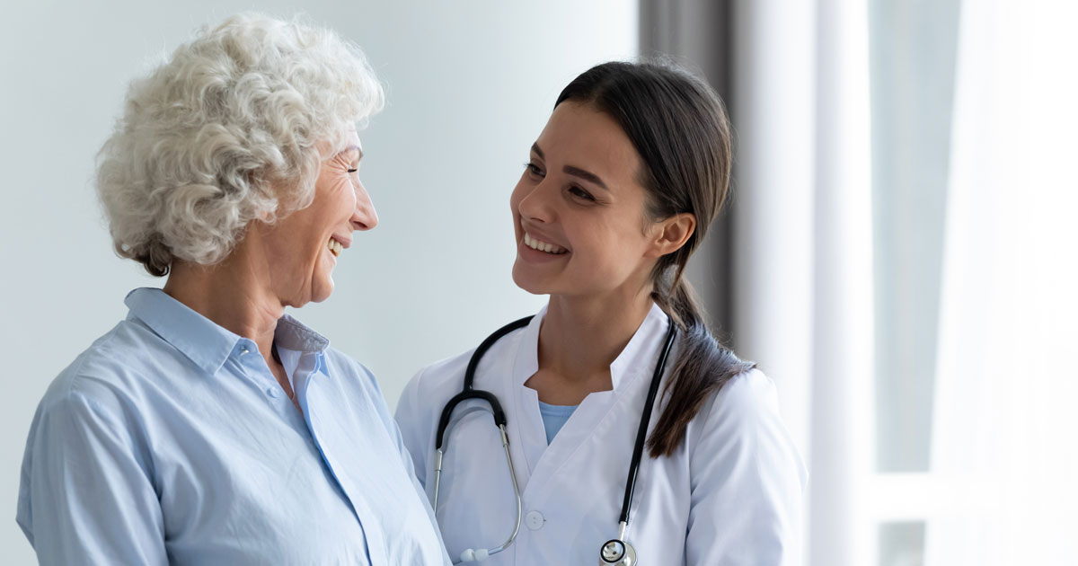 Female Caretaker Assisting Elderly Patient