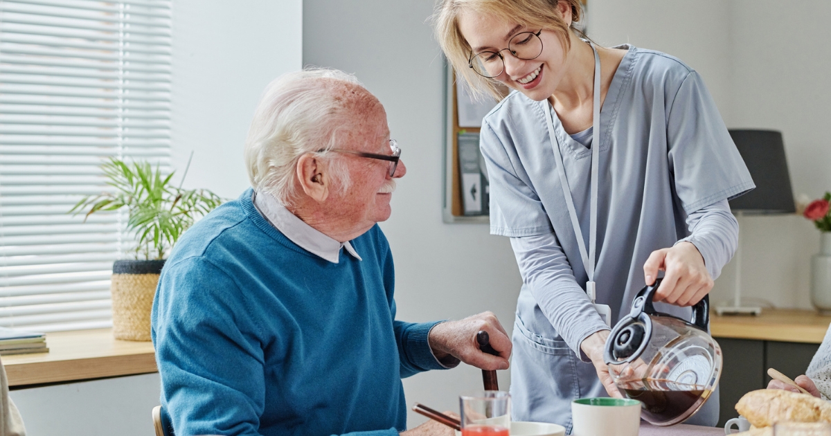 Woman Pouring Coffee for Elderly Man