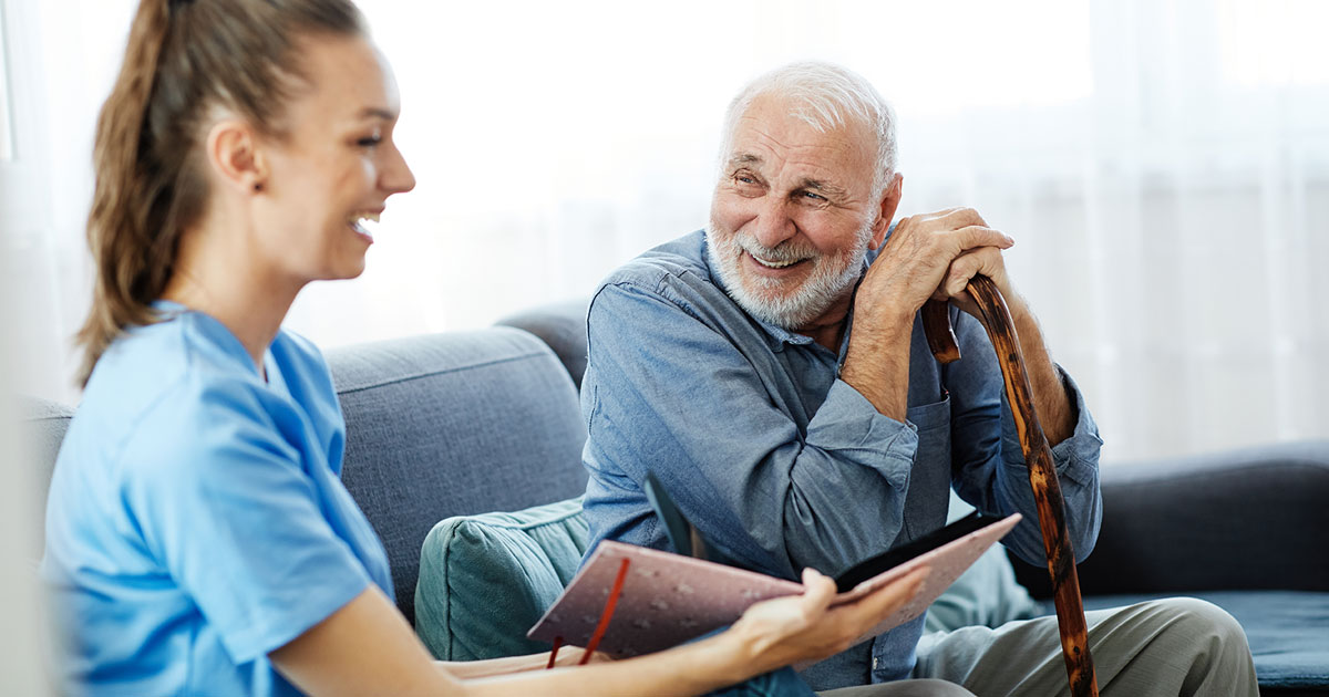 Nurse Showing Elderly Man Brochure