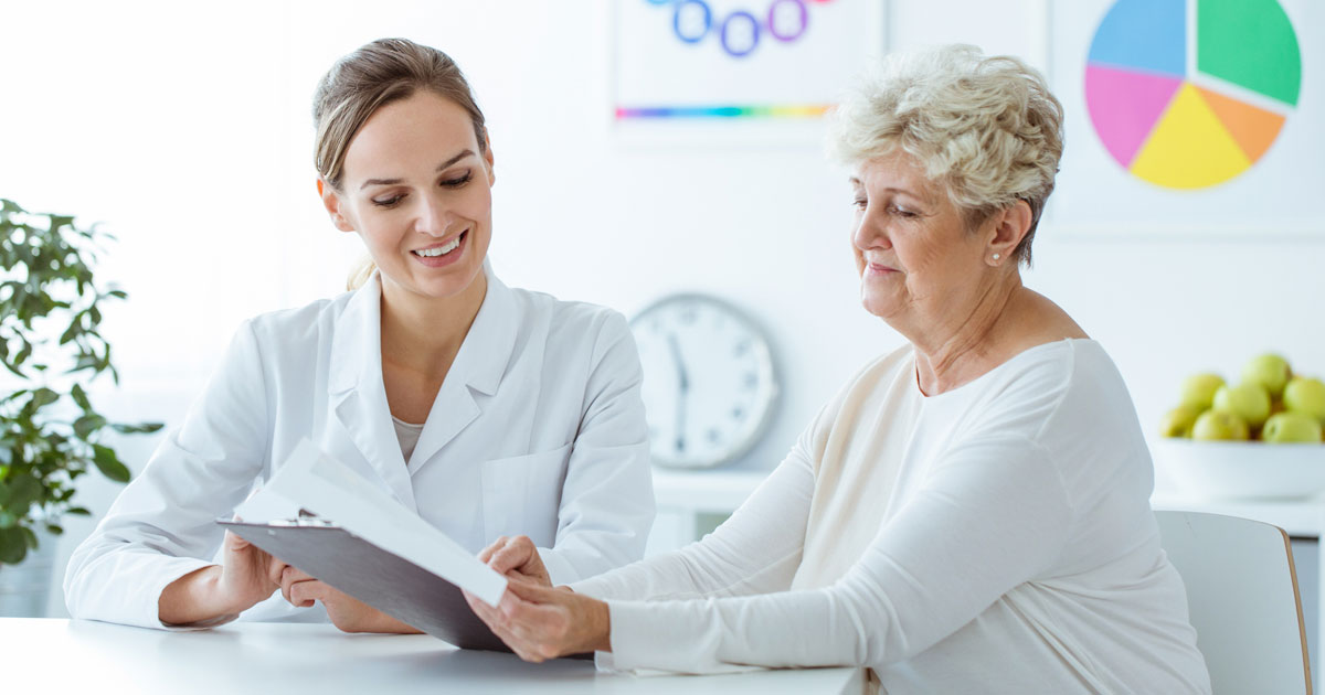 Nutritionist Showing Diet Plan to Elderly Woman