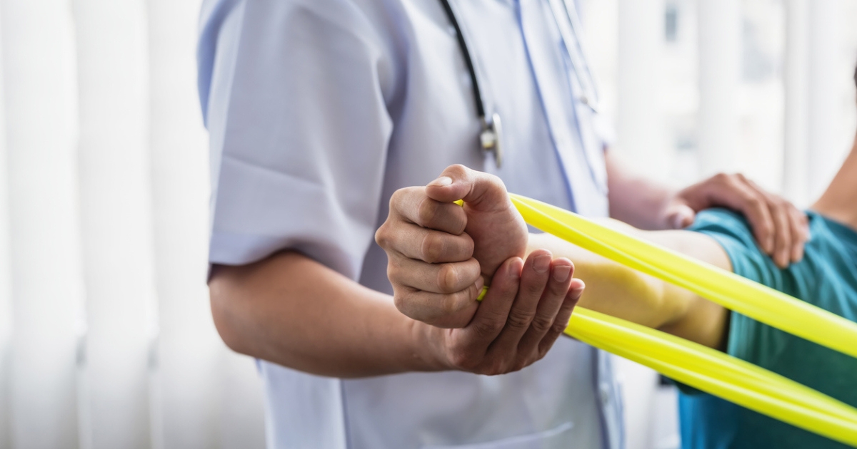 Physiotherapist Guiding Patient Through Stretch