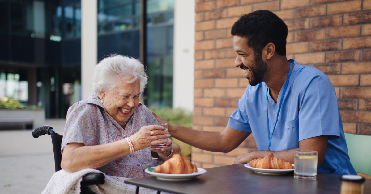 Home Health Aide Assisting Senior With Nutrition