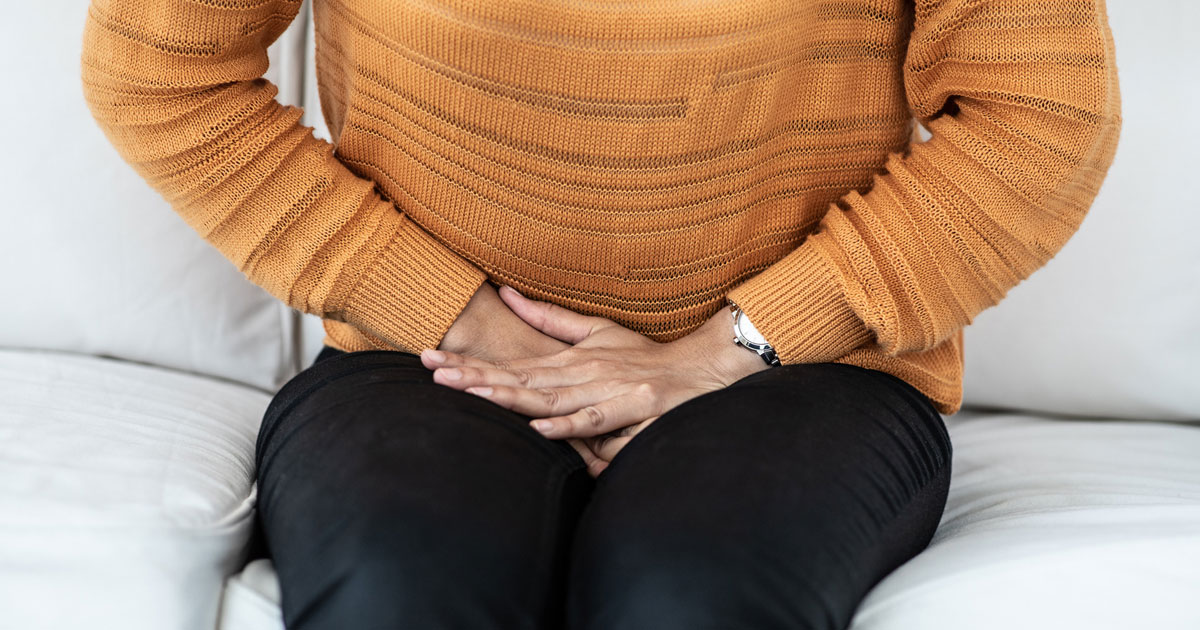 Woman Sitting With Bladder Pain