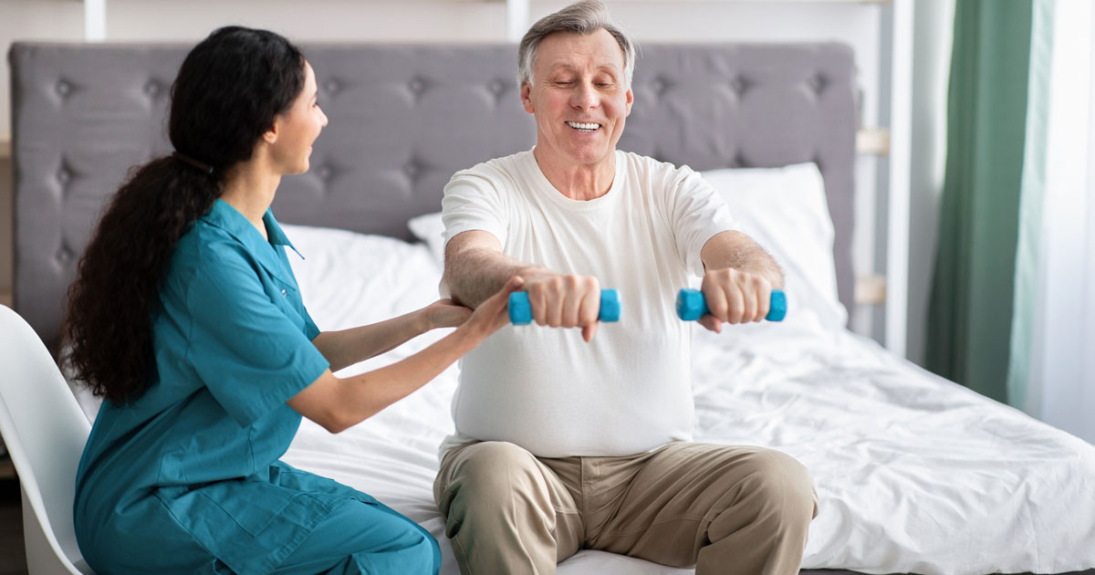Elderly Man Using Dumbbells on Bed